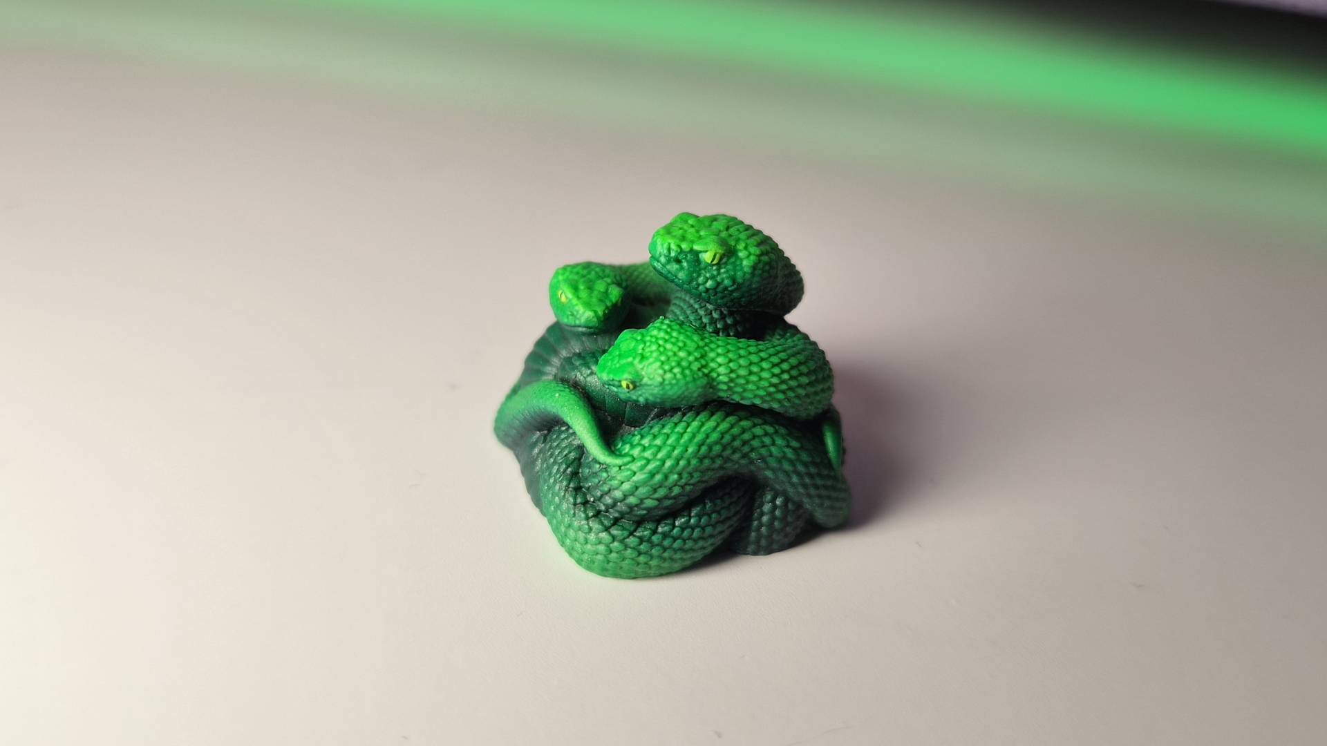 Photo of the Razer Artisan Keycap sitting alone on a white gaming desk.