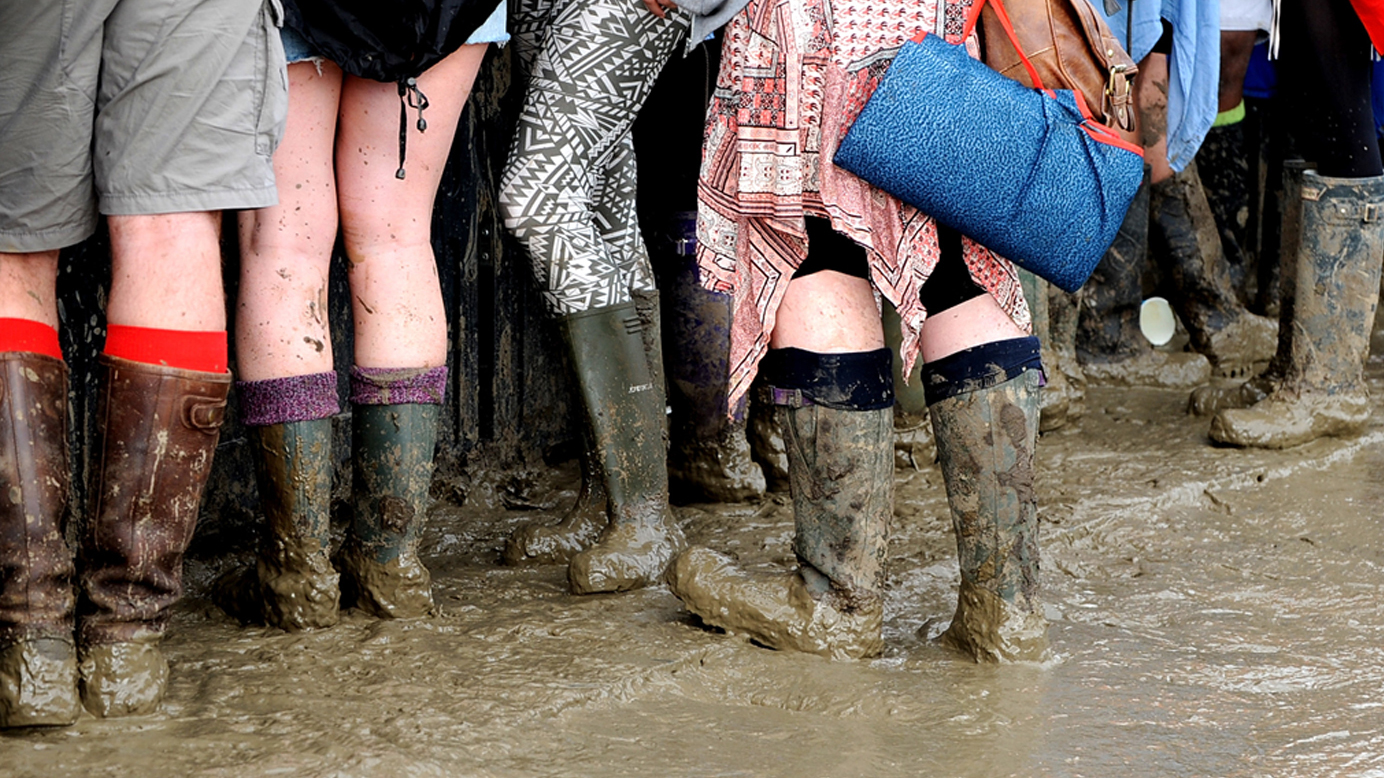 A picture of mud-covered music fans at Glastonbury festival 2016