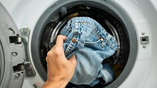 Putting clothes in a washing machine