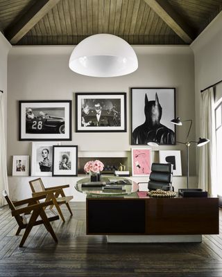 black and white office with mid century chairs and artworks on walls