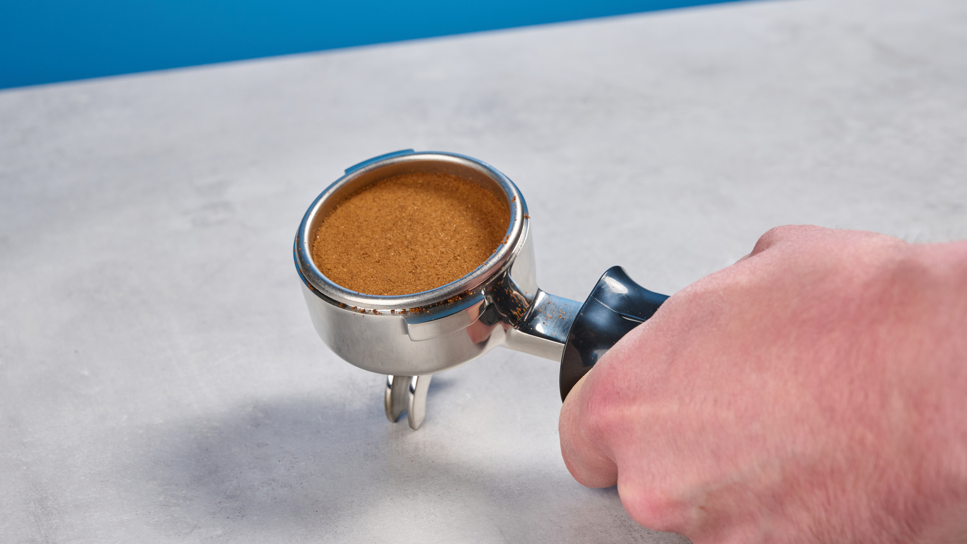 The Gaggia Classic E24 Evo Pro portafilter with coffee grounds tamped inside it