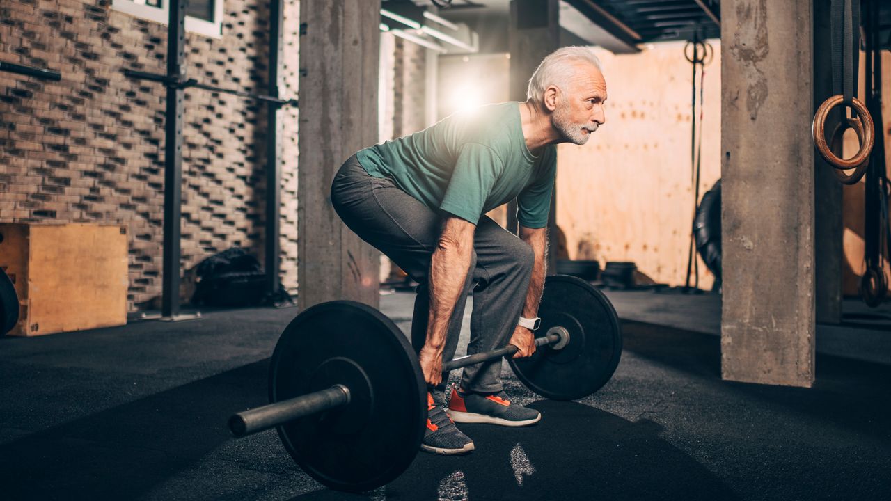 Senior man deadlifting