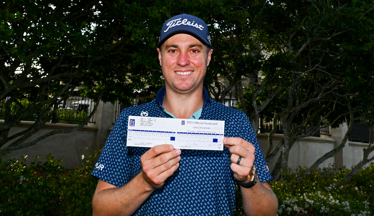 Justin Thomas holds his scorecard at TPC Sawgrass