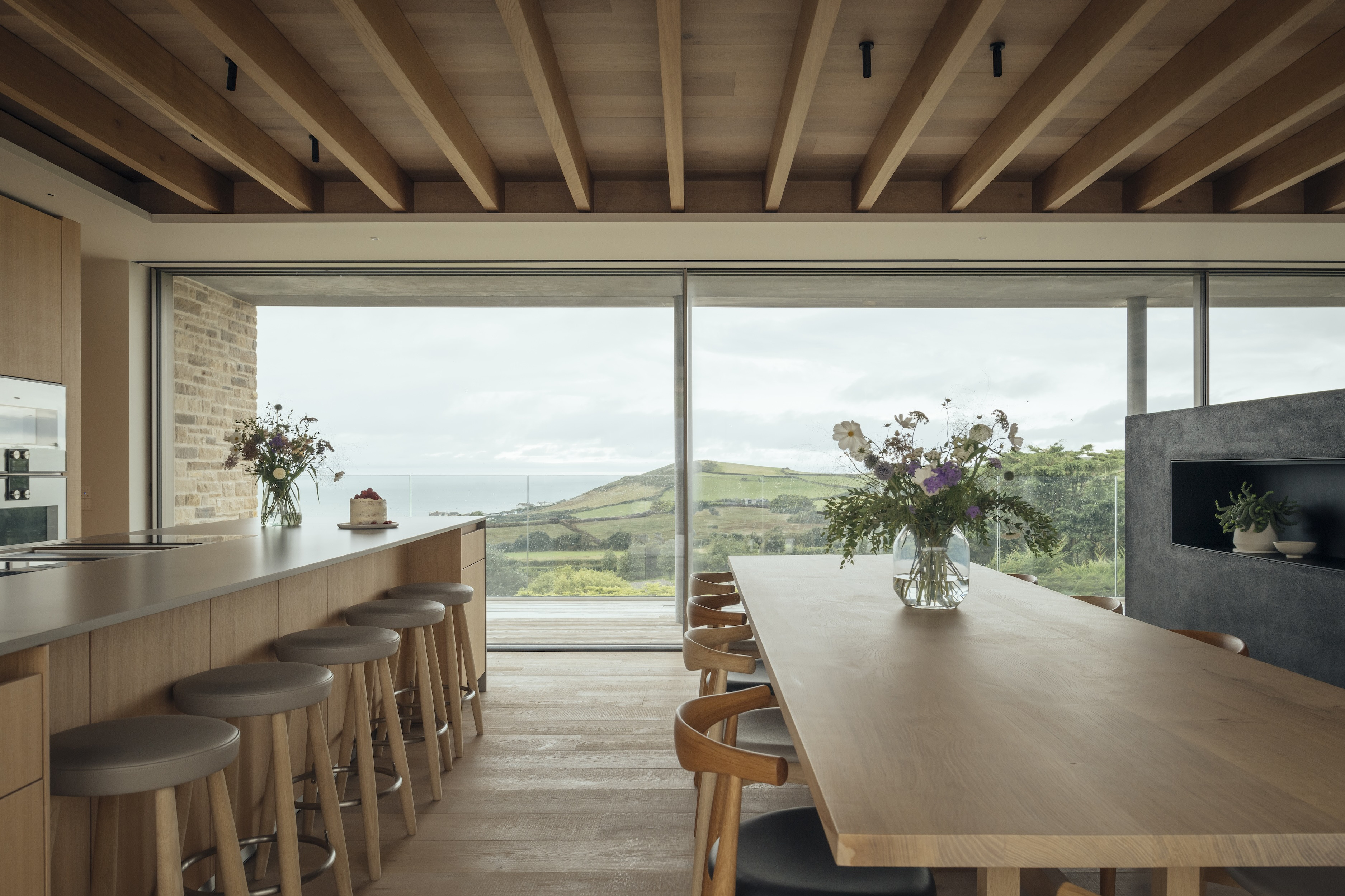 The kitchen and dining area look out to sea