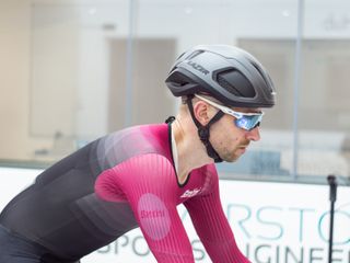 Tom riding in the wind tunnel wearing an aero helmet