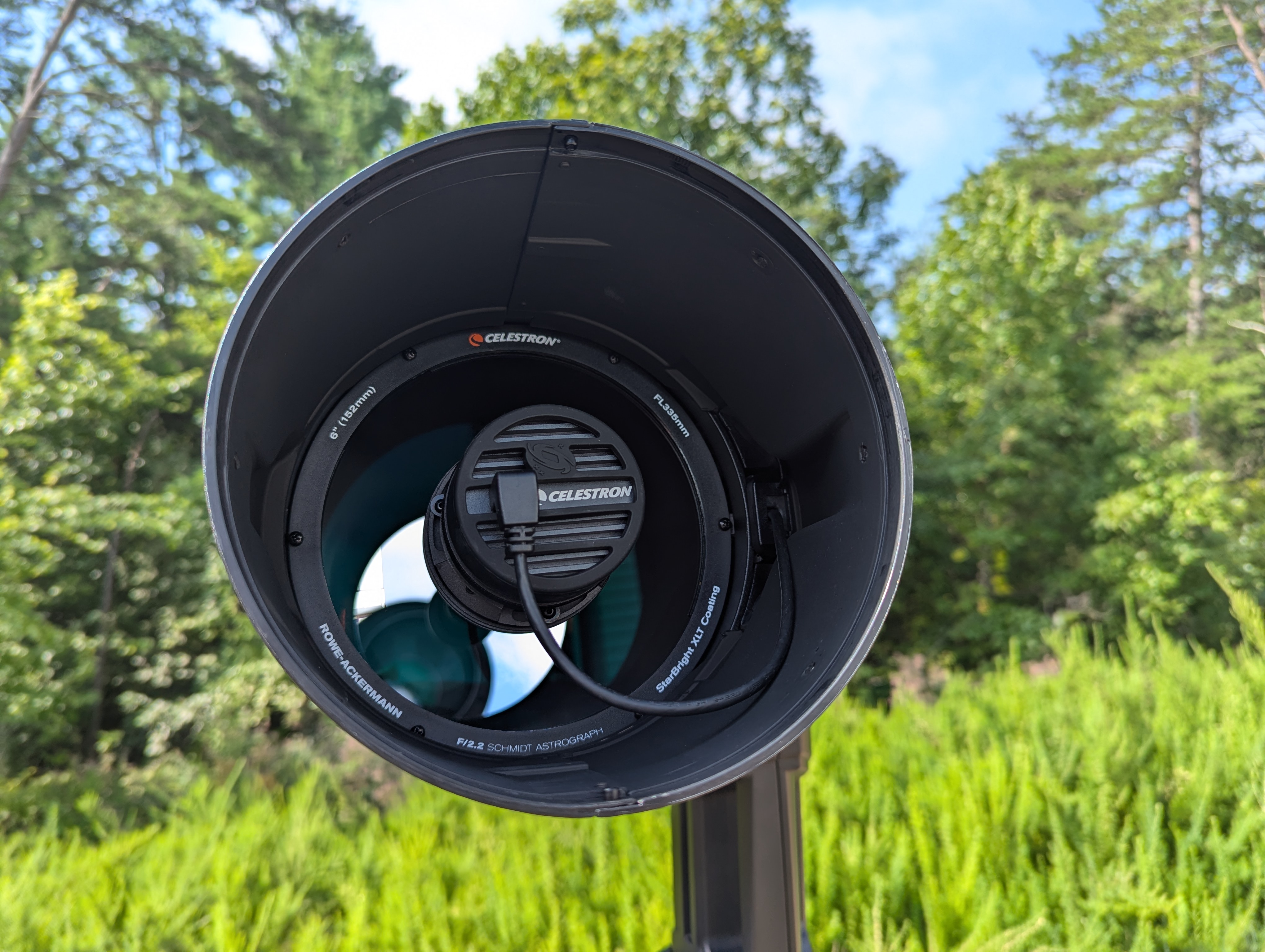 a view of the inside of a telescope, showing a large round mirror and a camera
