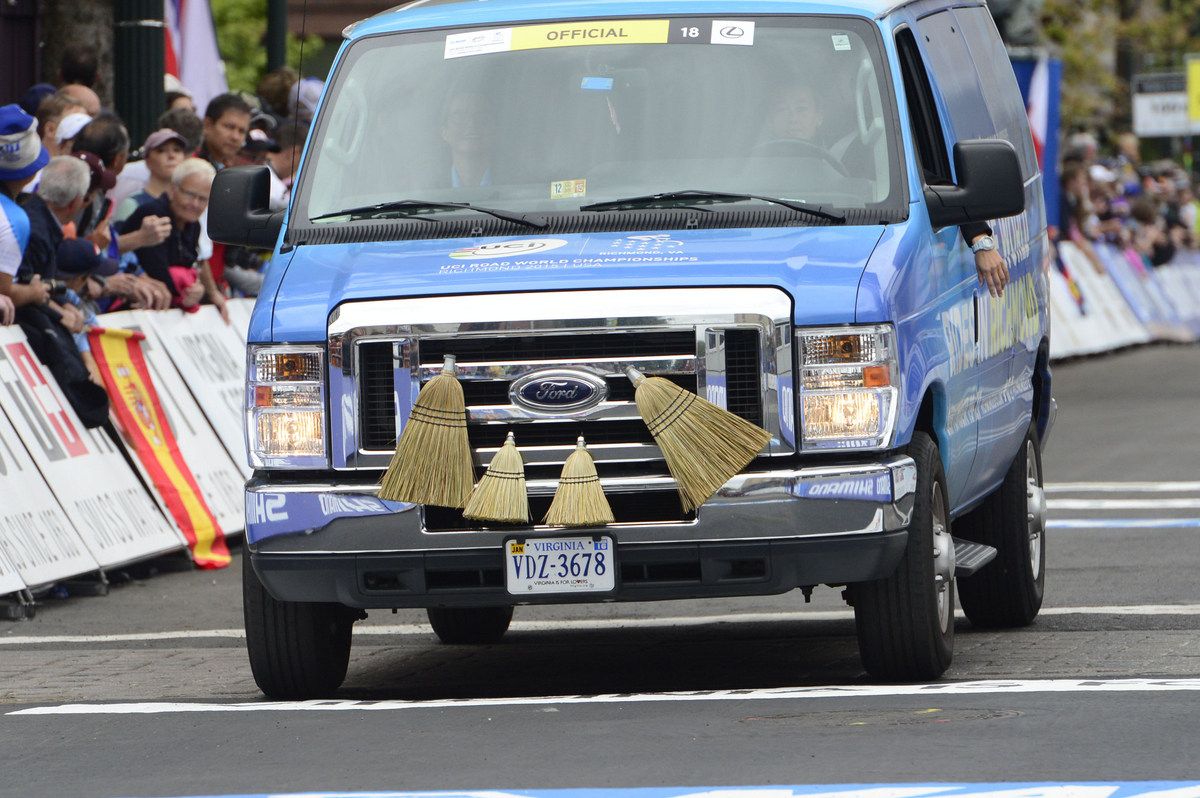 The broom wagon passes through the start/finish line