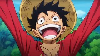 Luffy wears a straw hat, raising his arms to the sky while smiling with his mouth open