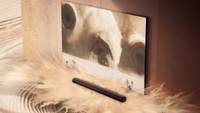 The Sonos Arc Ultra beneath a TV playing Dune Part 2 with a sand erupting from the soundbar