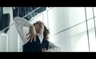 Image of film clip-Person wears white shirt and waistcoat
