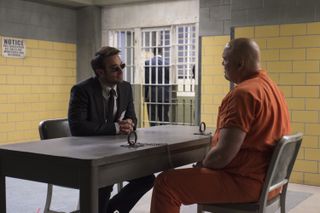 matt murdock and kingpin at table in prison cell
