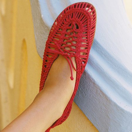 A pair of red knitted flats.