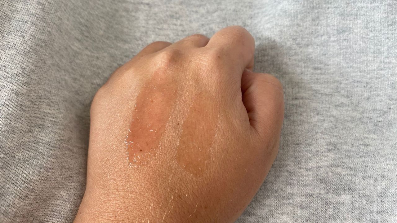 hand with dior and collection lip oil swatches
