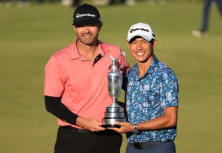 Collin Morikawa and caddie Jonathan Jakovac celebrate with the Claret Jug after winning The Open at Royal St George's Golf Club in 2021