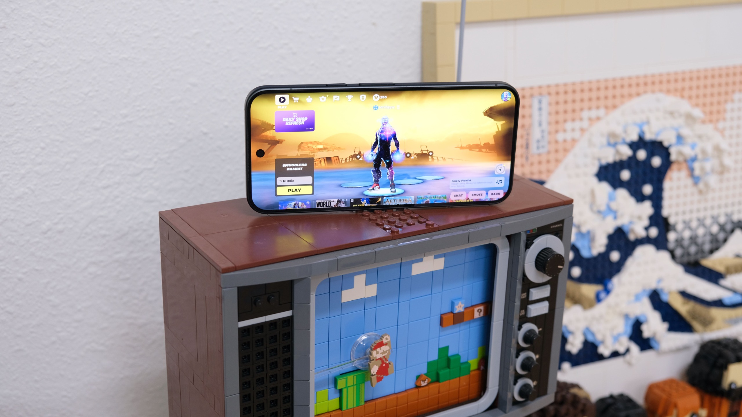 The Google Pixel 11 Pro XL displaying Fortnite while resting on a Lego TV set