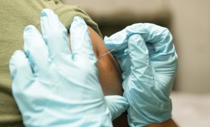 A U.S. Navy officer receives an anthrax vaccination: The government is considering expanding the inoculations that would protect from possibly bio terrorism acts from military people to child