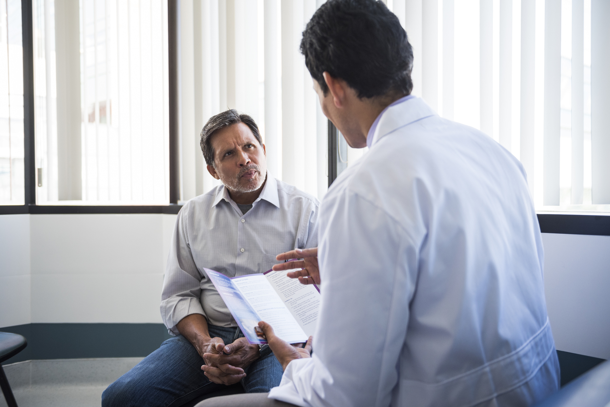 Older man talking to his doctor