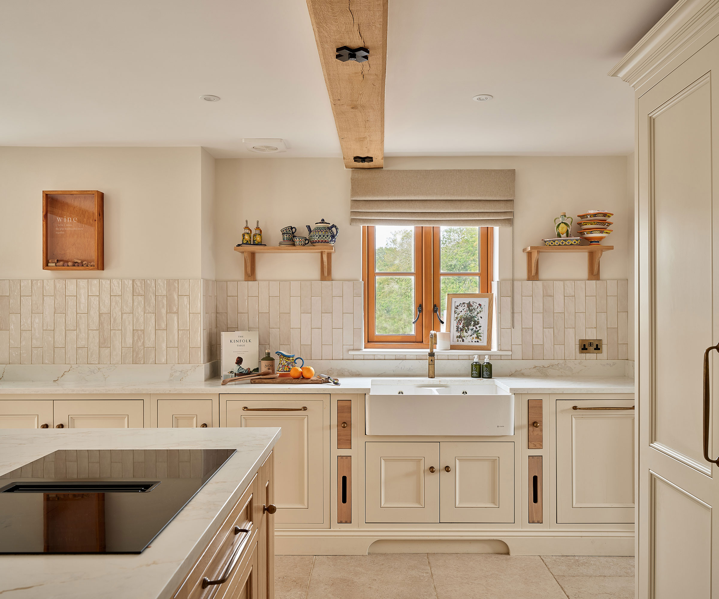 cream Shaker kitchen with vertical metro tiles and stone flooring