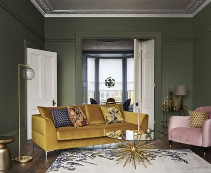 mustard yellow velvet sofa with Aquaclean in green living room