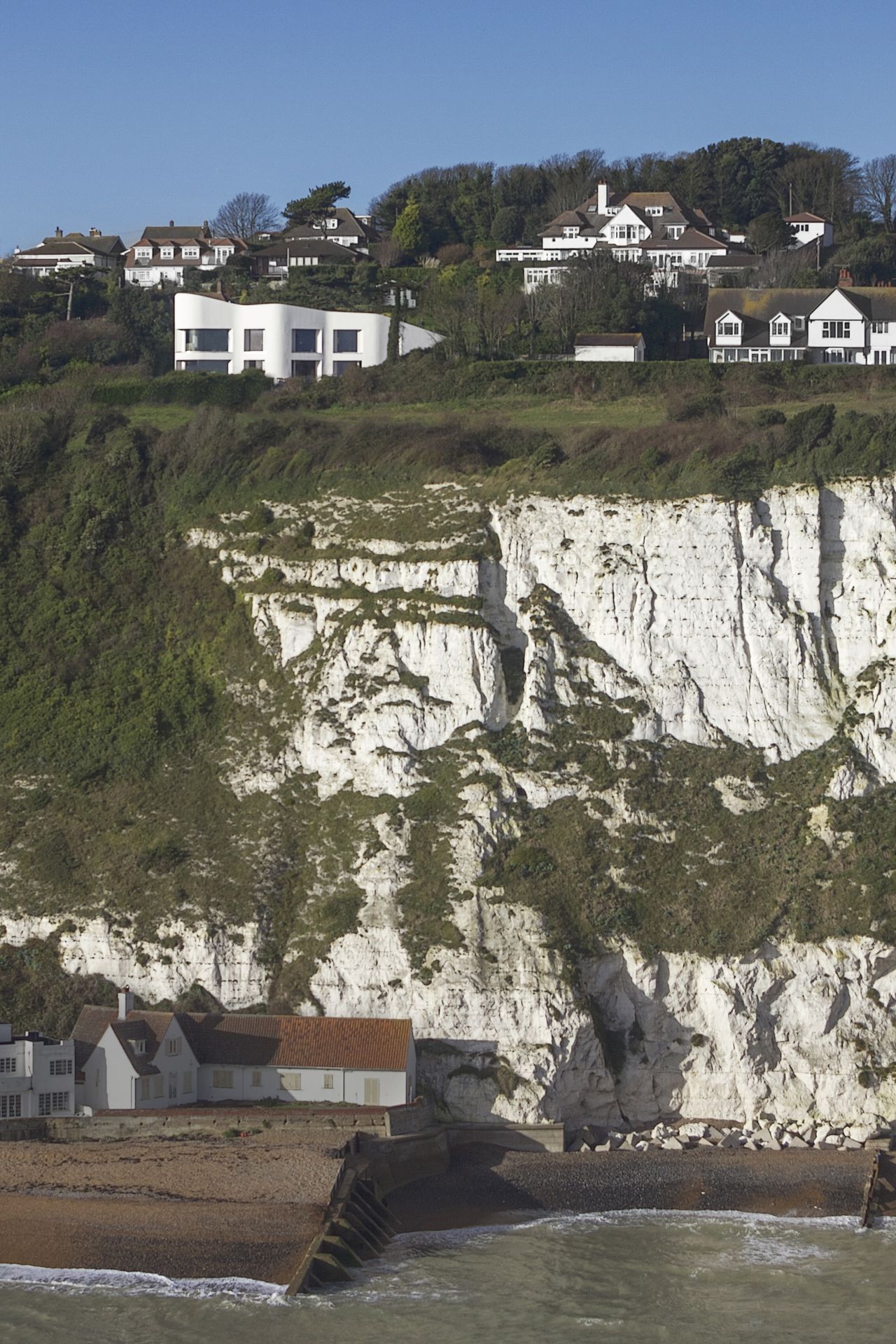 exterior of white self build on cliff edge