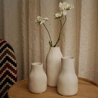 three textured ceramic vases of different heights