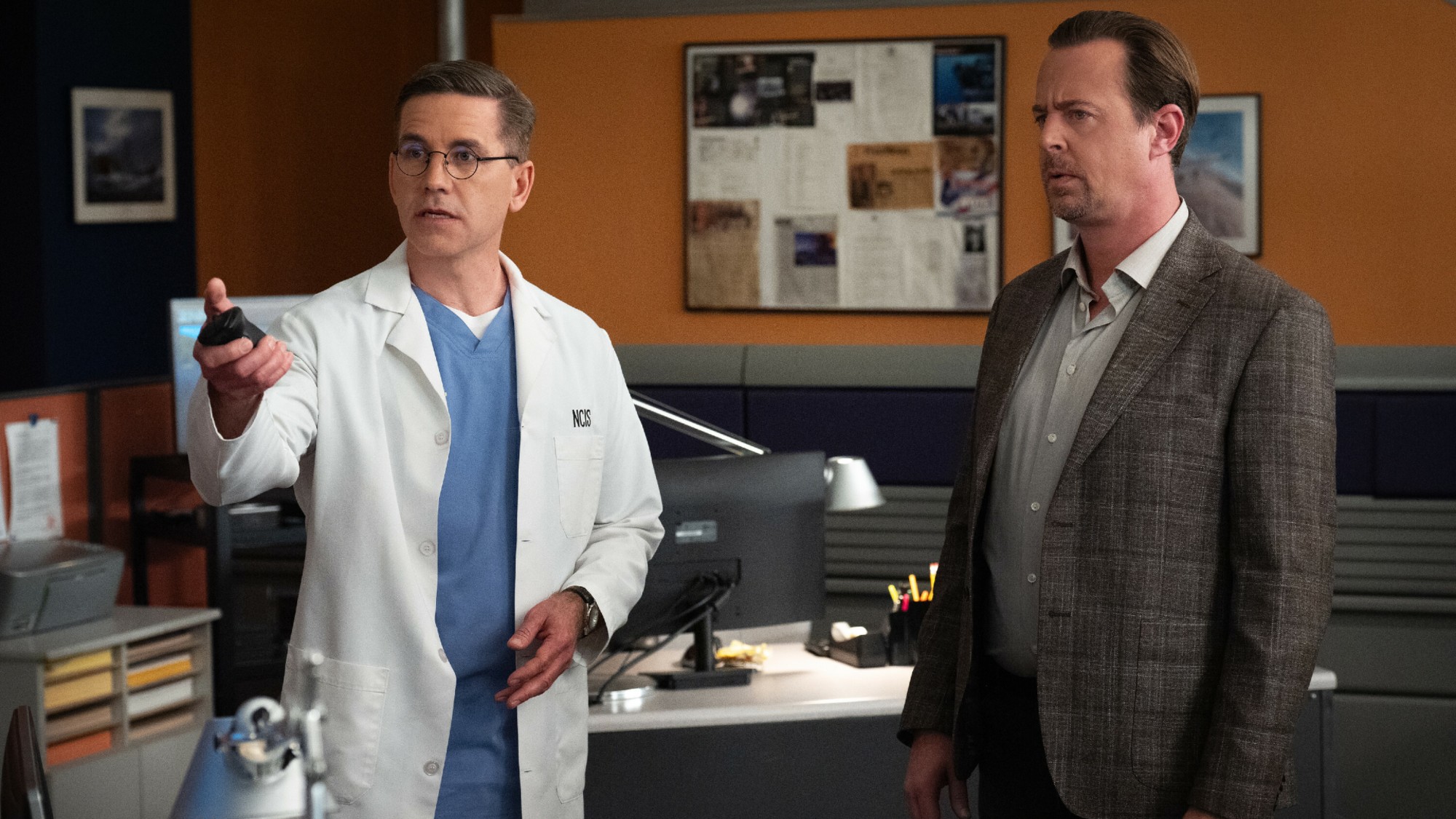 Jimmy pointing and McGee looking on NCIS.