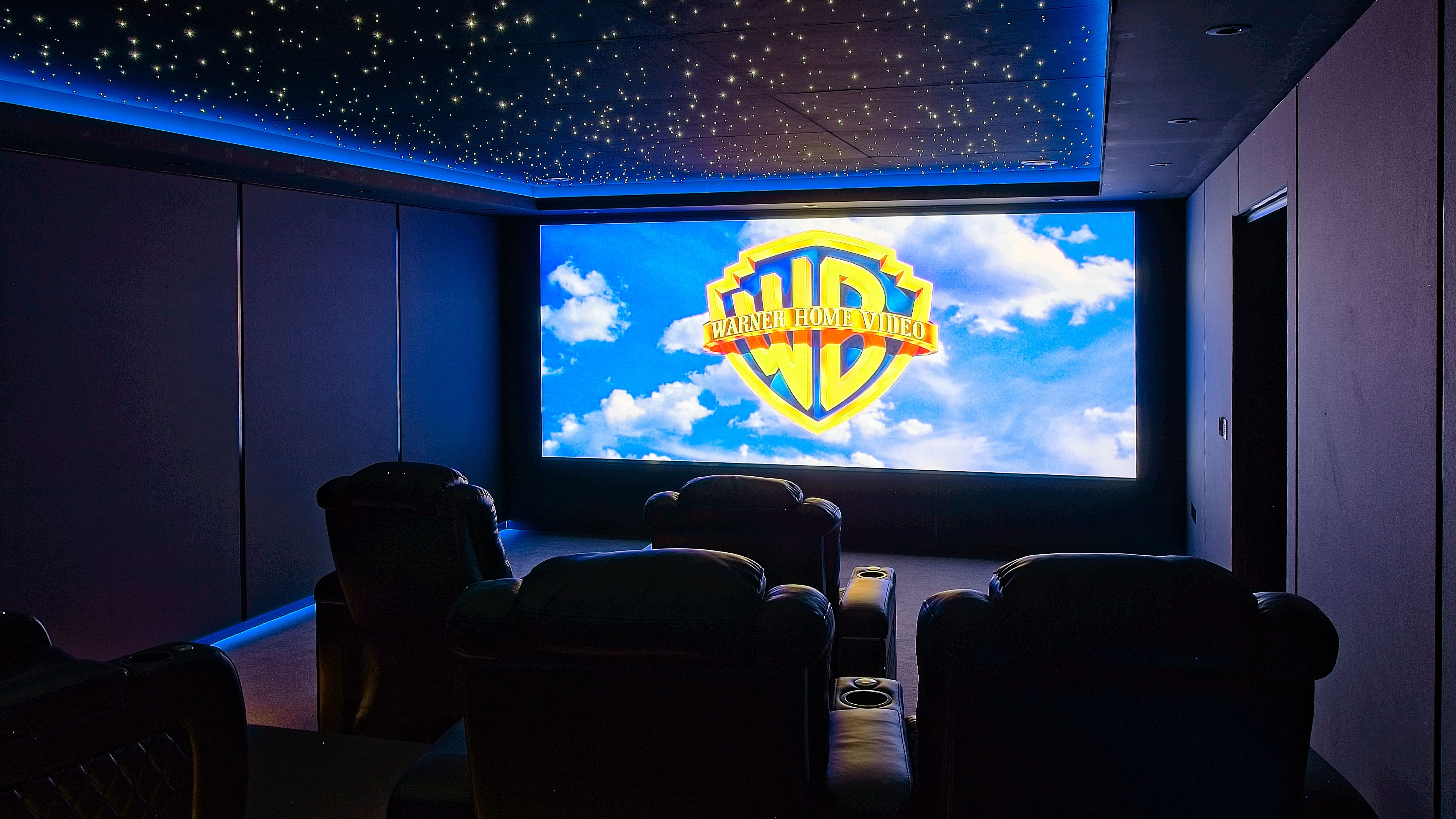 Warwickshire home theater showing seating, projection screen and starlight ceiling