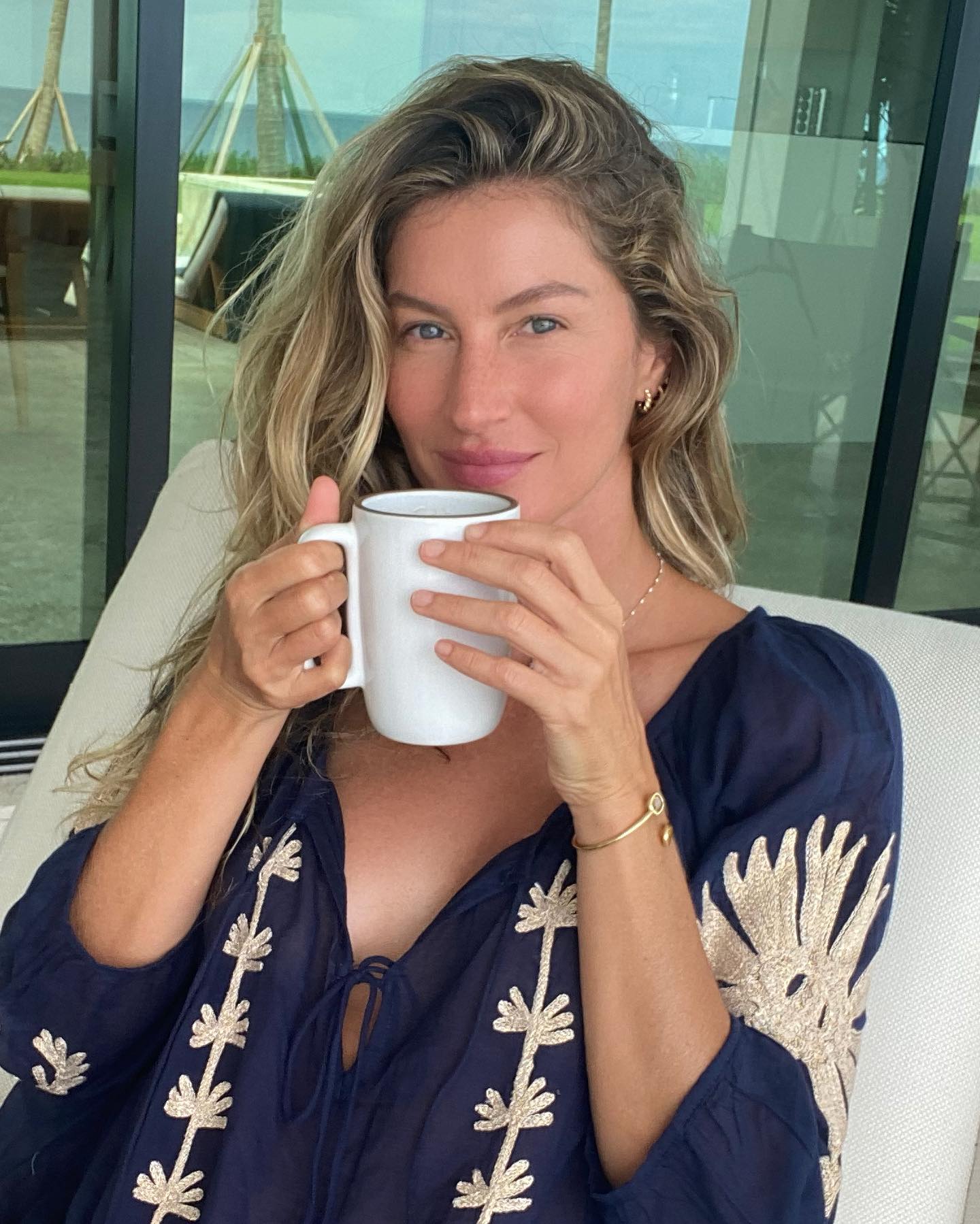 Gisele Bundchen drinking tea with natural-looking makeup