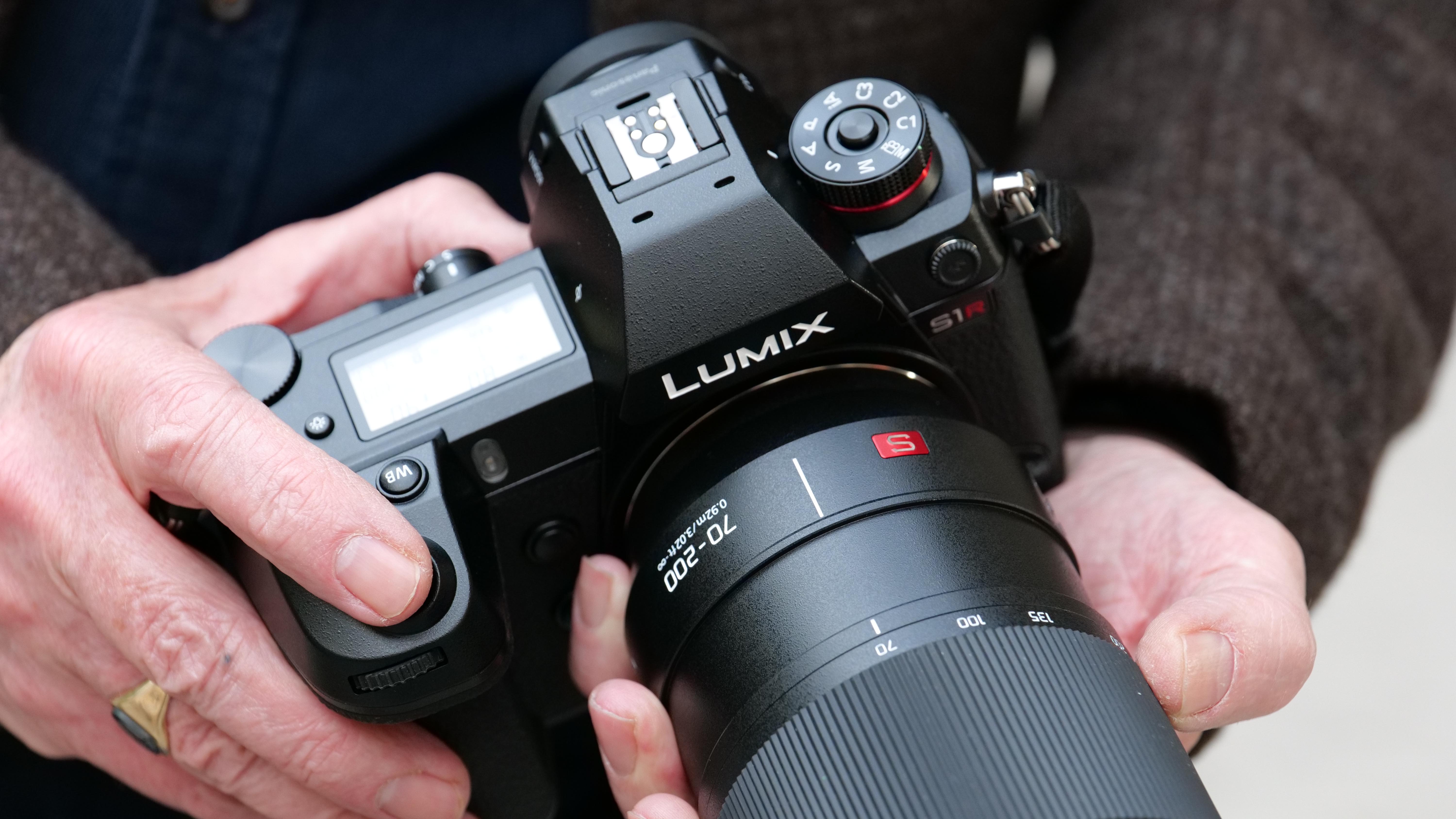 Someone holding the Lumix S1R