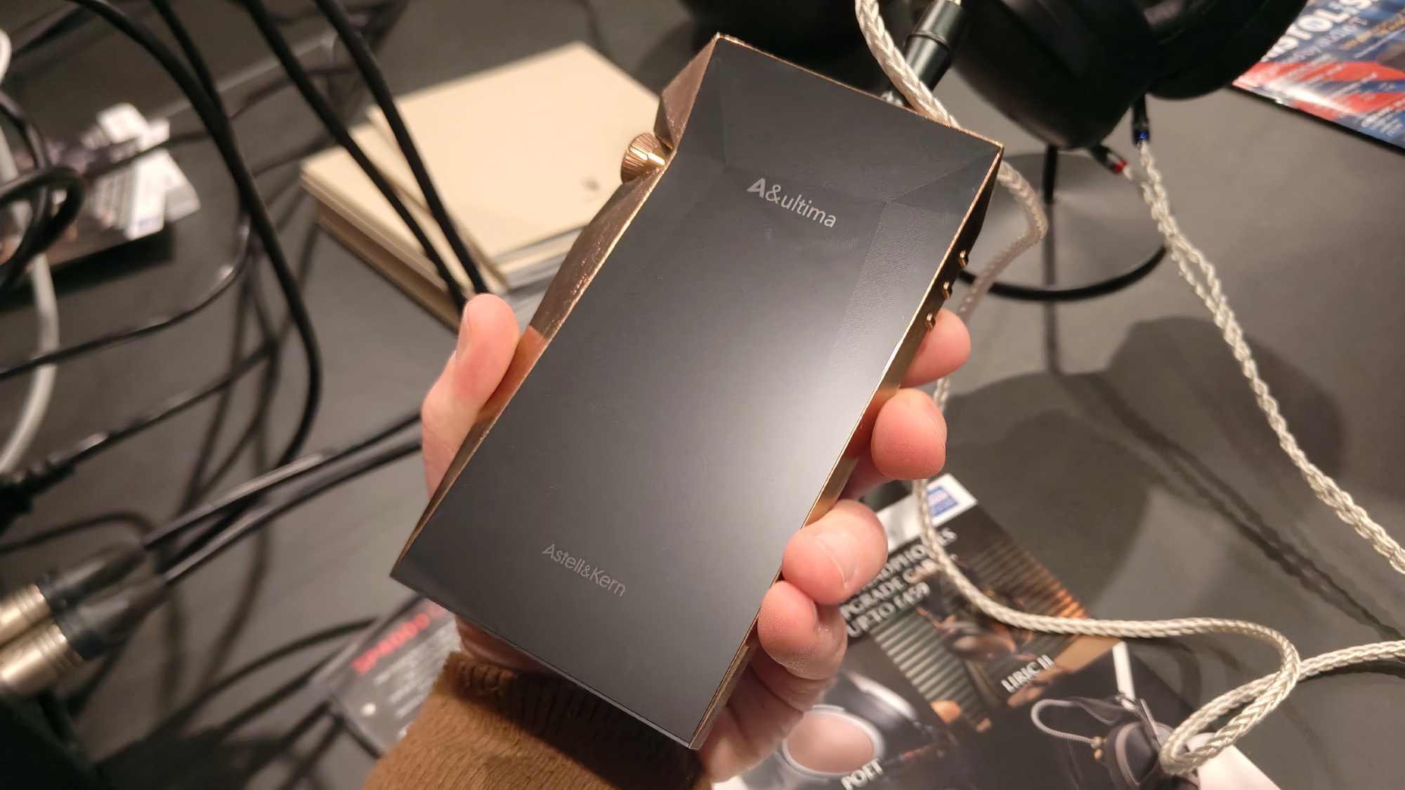 The Astell &amp; Kern SP4000 Copper in a man's hand.