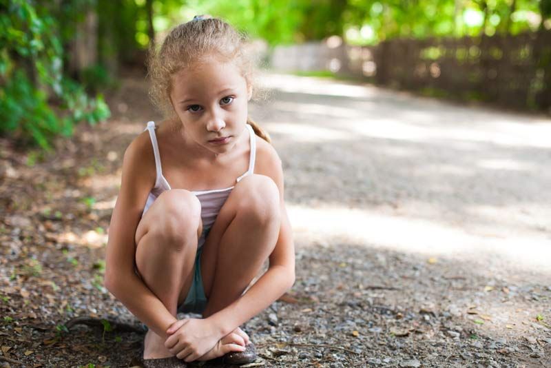 Stressed girl sits in the forest.