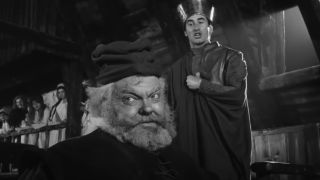 Orson Welles as Falstaff in Chimes by Midnight with a man standing behind him.