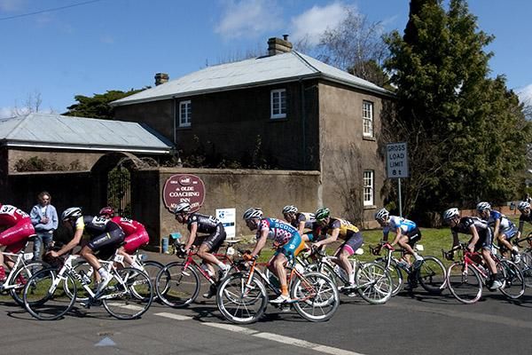 Riders corner around an old Inn at Westbury during the final stage criterium.