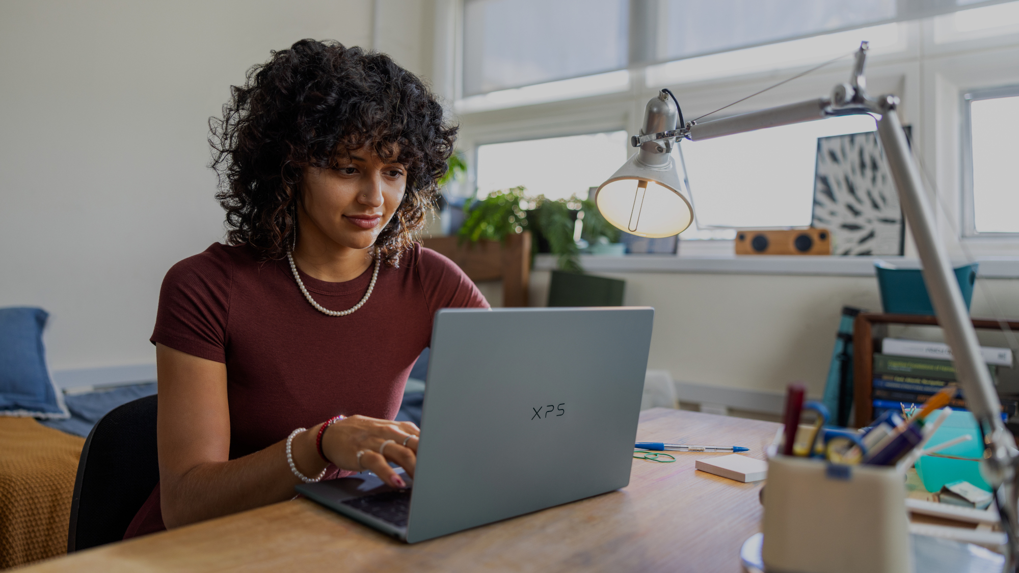 Dell XPS 13 laptop being used by a student sat at a desk