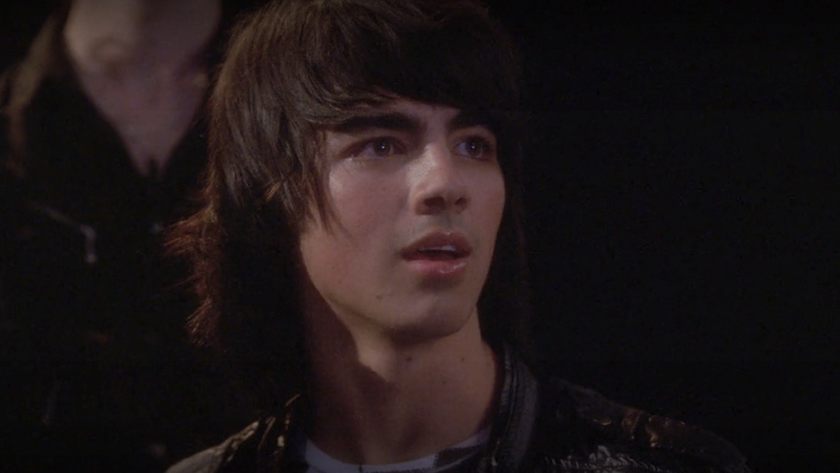 Joe Jonas looking back in amazement at the end of Camp Rock 