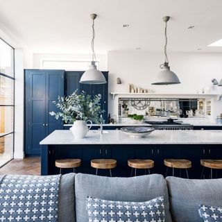 kitchen with white and navy coloured and stools