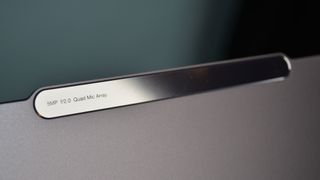 A Lenovo Slim Pro 9i on a desk with a green desk mat