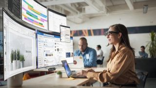 Image of a woman wearing AR glasses working in the Spacetop workspace.