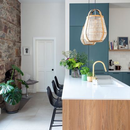 White kitchen walls with navy cabinets and wooden kitchen island