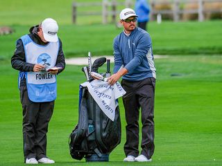 Rickie Fowler cleaning and drying his golf gear in very wet conditions at the Pebble Beach Pro-Am 2024