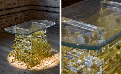 Translucent yellow glass table shown in two different points of view, which was created by Bethan Laura Wood for Wonderglass, placed on a wooden floor in front of a brick wall