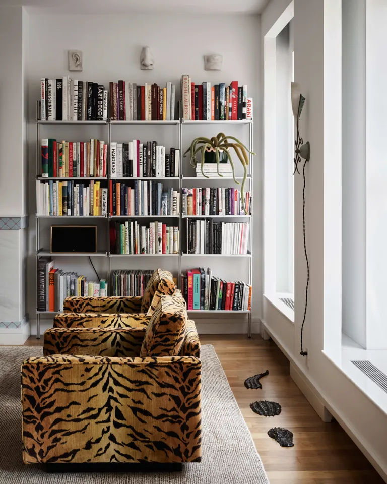 Living room with bookshelf and animal print chairs