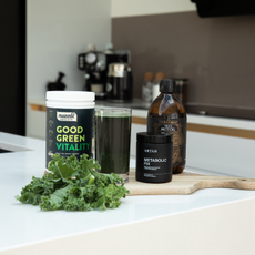 A variety of W-Wellness products on a wooden chopping board in a kitchen.