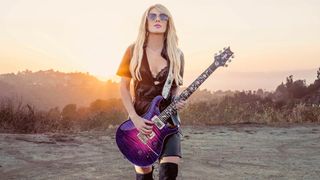 Orianthi holds her signature PRS Private Stock model