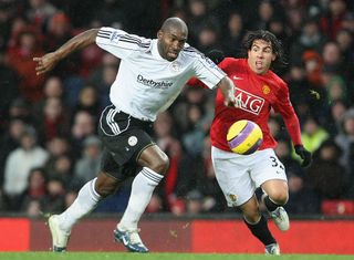 MANCHESTER, ENGLAND - DECEMBER 8: Carlos Tevez of Manchester United clashes with Darren Moore of Derby County during the Barclays FA Premier League match between Manchester United and Derby County at Old Trafford on December 8 2007, in Manchester, England. (Photo by Matthew Peters/Manchester United via Getty Images)