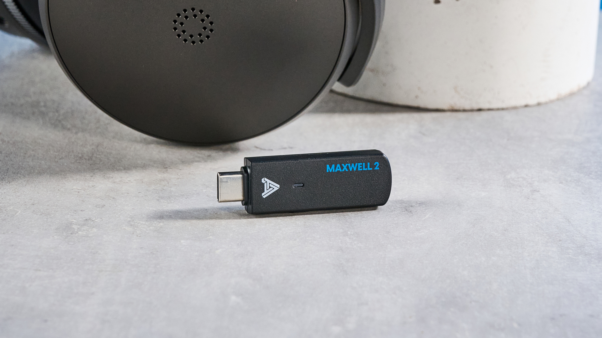 Audeze Maxwell 2 dongle on a stone surface