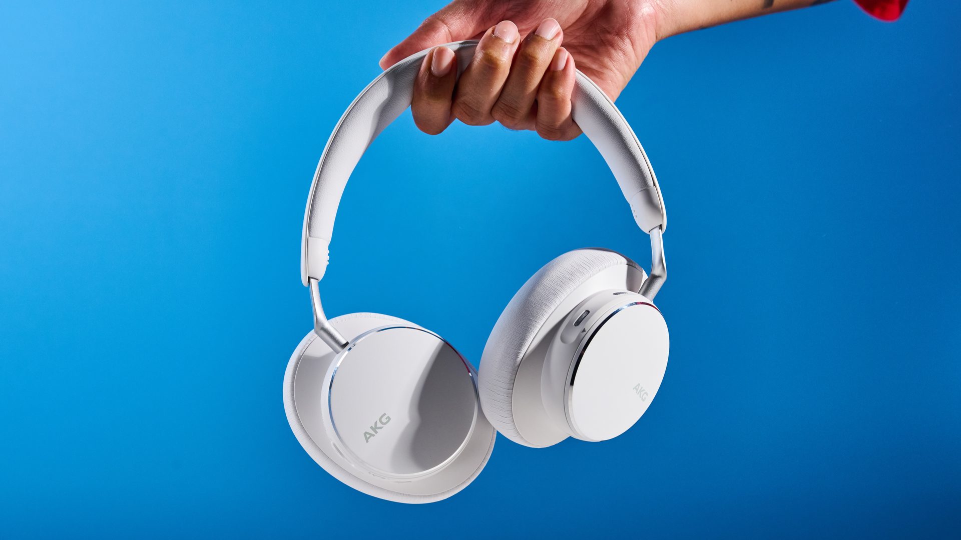 The AKG N9 Hybrid headphones photographed in front of a blue background.