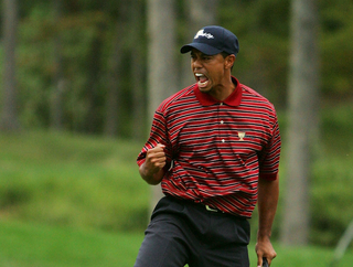 Tiger Woods celebrates holing a putt in the Presidents Cup