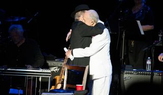 Micky Dolenz (left) and Michael Nesmith of The Monkees embrace during the final show of "The 55th Anniversary Farewell Tour" at The Greek Theatre on November 14, 2021 in Los Angeles, California