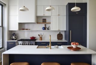 A kitchen with white or dark blue cabinets